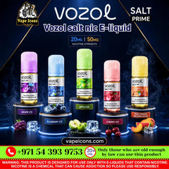 A promotional graphic for Vozol Salt Prime e-liquid by Vape Icons, showing five flavor bottles on illuminated pedestals: Grape Ice, Blueberry Ice, Apple Ice, Cherry Ice, and Peach Mango Mint Juice. The bottles have colorful caps and labels, with fruit illustrations and a dark smoky background.